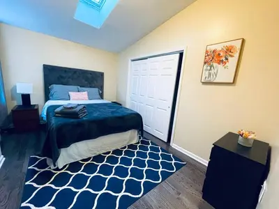 a bedroom with a bed with a blue blanket and a rug at Cozy 1BD Apt - Magic Garden in Center City in Philadelphia