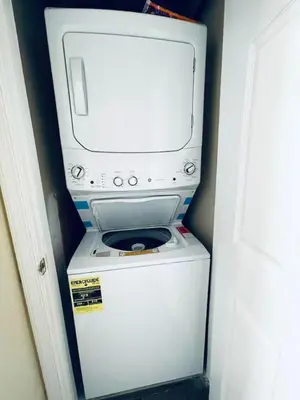 a washer and dryer with a computer on top of it at Cozy 1BD Apt - Magic Garden in Center City in Philadelphia