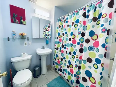 a bathroom with a toilet and a shower curtain at Cozy 1BD Apt - Magic Garden in Center City in Philadelphia