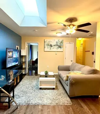 a living room with a couch and a tv at Cozy 1BD Apt - Magic Garden in Center City in Philadelphia
