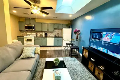 a living room with a couch and a flat screen tv at Cozy 1BD Apt - Magic Garden in Center City in Philadelphia