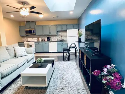 a living room with a couch and a kitchen at Cozy 1BD Apt - Magic Garden in Center City in Philadelphia