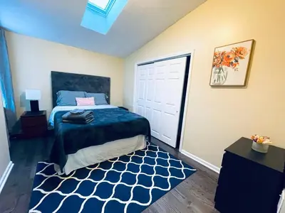 a bedroom with a bed with a blue comforter and a rug at Cozy 1BD Apt - Magic Garden in Center City in Philadelphia