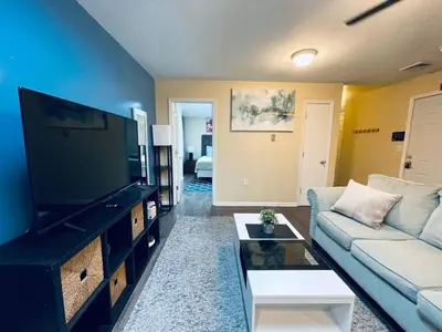 a living room with a couch and a flat screen tv at Cozy 1BD Apt - Magic Garden in Center City in Philadelphia