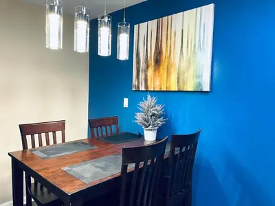 a dining room table with chairs and a painting on the wall at Cozy Beautiful 2BD Apt in Center City in Philadelphia