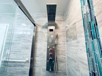 a walk in shower with a glass door at Cozy Beautiful 2BD Apt in Center City in Philadelphia