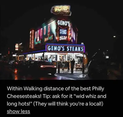 a sign for a restaurant on a city street at night at Cozy Beautiful 2BD Apt in Center City in Philadelphia