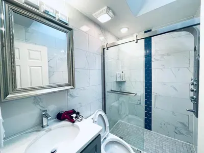 a bathroom with a shower and a sink and a toilet at Cozy Beautiful 2BD Apt in Center City in Philadelphia