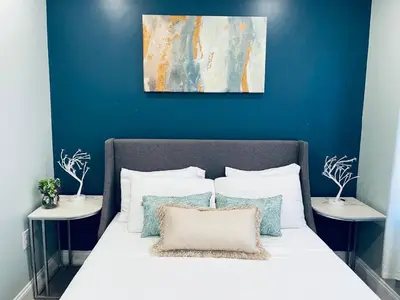 a bedroom with a bed with a blue wall at Rittenhouse Square nearby Kimmel Center 1BD in Philadelphia