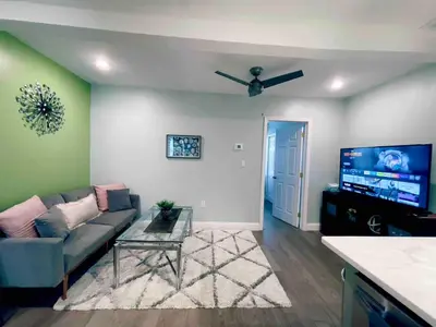 a living room with a couch and a flat screen tv at Rittenhouse Square nearby Kimmel Center 1BD in Philadelphia