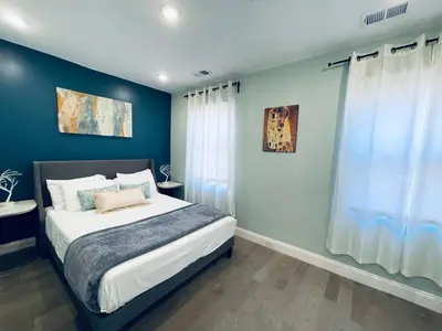 a bedroom with a large bed with blue walls at Rittenhouse Square nearby Kimmel Center 1BD in Philadelphia