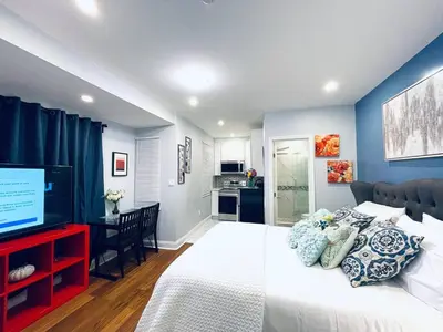 a bedroom with a large bed and a television at Downtown City Hall close by Kimmel Center Suite in Philadelphia