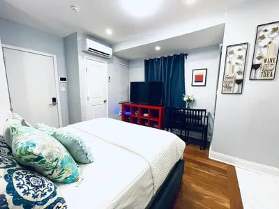 a hotel room with a bed and a television at Downtown City Hall close by Kimmel Center Suite in Philadelphia