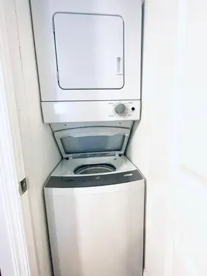 a washer and dryer in a small room at Downtown City Hall close by Kimmel Center Suite in Philadelphia