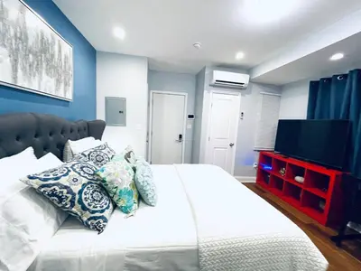 a bedroom with a bed with pillows and a television at Downtown City Hall close by Kimmel Center Suite in Philadelphia