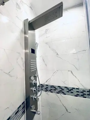 a shower in a bathroom with white marble at Downtown City Hall close by Kimmel Center Suite in Philadelphia