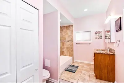 a white bathroom with a toilet and a sink at Modern Home w. Deck in Passyunk Square in Philadelphia