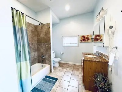 a bathroom with a tub and a toilet and a sink at Beautiful 1BD Apt with Roofdeck in Passyunk Square in Philadelphia