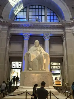 a statue in a building with people standing around it at Beautiful 1BD Apt with Roofdeck in Passyunk Square in Philadelphia