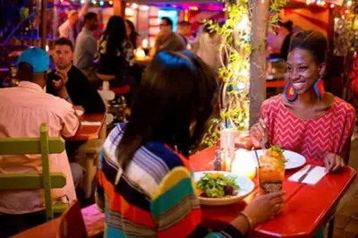 a group of people sitting at a table in a restaurant at Beautiful 1BD Apt with Roofdeck in Passyunk Square in Philadelphia