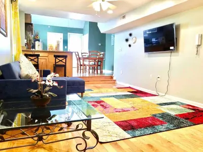 a living room with a couch and a table at Beautiful 1BD Apt with Roofdeck in Passyunk Square in Philadelphia