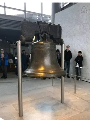 a large bronze bell on display in a building at Downtown City Hall near Rittenhouse Square 1 BD in Philadelphia