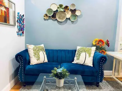 a blue couch in a living room with a table at Downtown City Hall near Rittenhouse Square 1 BD in Philadelphia