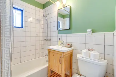 a bathroom with a sink and a toilet and a tub at Waterfront Studio with Loft and Dock Near Narrowsburg! in Narrowsburg