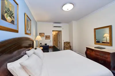 a bedroom with a bed and a desk and a mirror at 3 West Club in New York
