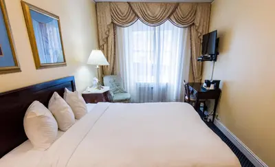 a hotel room with a large bed and a window at 3 West Club in New York