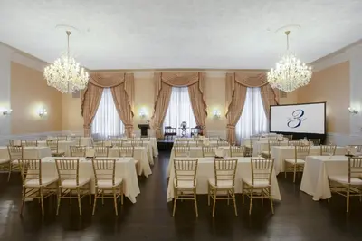 a banquet hall with tables and chairs and a screen at 3 West Club in New York