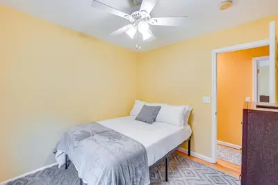 a bedroom with a bed and a ceiling fan at 4 Mi to Hudson River Cozy Newburgh Home! in Newburgh