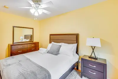 a bedroom with a bed and a dresser and a mirror at 4 Mi to Hudson River Cozy Newburgh Home! in Newburgh