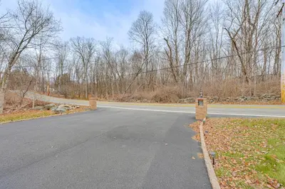 an empty road in the middle of a forest at 4 Mi to Hudson River Cozy Newburgh Home! in Newburgh