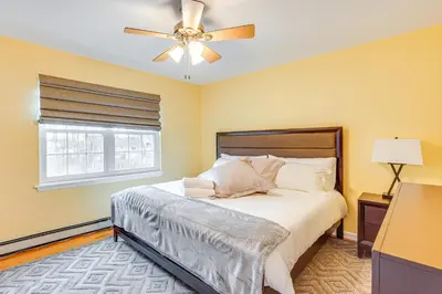 a bedroom with a bed and a ceiling fan at 4 Mi to Hudson River Cozy Newburgh Home! in Newburgh