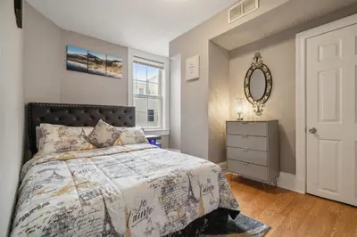 a bedroom with a bed and a dresser and a mirror at The Prime in Philadelphia