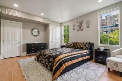 a bedroom with a bed and a chair and a window at The Prime in Philadelphia