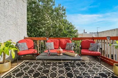 a patio with two red chairs and a table at The Prime in Philadelphia