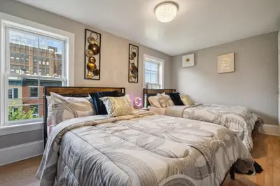 two beds in a room with two windows at The Prime in Philadelphia