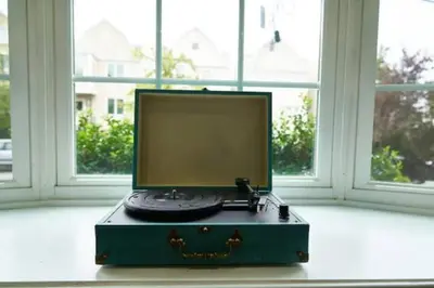 a computer monitor sitting on top of a chest in front of a window at Music - Big 3br with King Bd Close to EWR and NYC in Bayonne