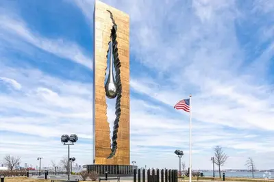 a tall obelisk with an american flag in front at Music - Big 3br with King Bd Close to EWR and NYC in Bayonne