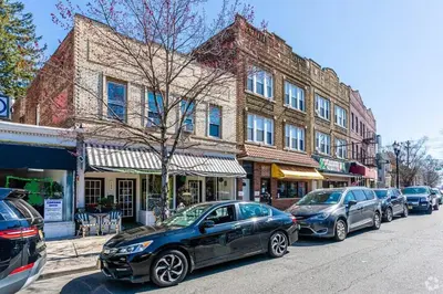 a group of cars parked in front of a building at Movie - 4 bedroom with King bed, deck and 80 in Movie Screen in Bayonne