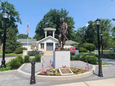 a statue of a man with a spear in a park at Movie - 4 bedroom with King bed, deck and 80 in Movie Screen in Bayonne