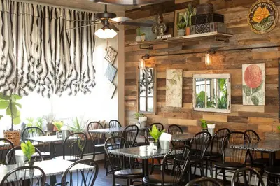 a restaurant with tables and chairs in a room with wooden walls at Movie - 4 bedroom with King bed, deck and 80 in Movie Screen in Bayonne