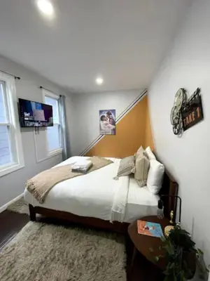 a bedroom with a large bed and a window at Movie - 4 bedroom with King bed, deck and 80 in Movie Screen in Bayonne