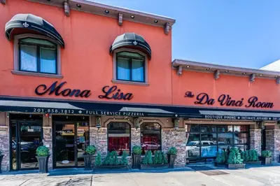 a red building with a sign for a momma line at Duplex apt - Dining - 80in Projector - Pool Table in Bayonne