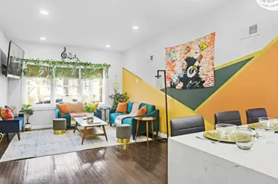 a living room with colorful furniture and a table at W3S - Large 7br 3bath - Sleeps 20 - 3 Living rooms - Yard and Deck in Bayonne