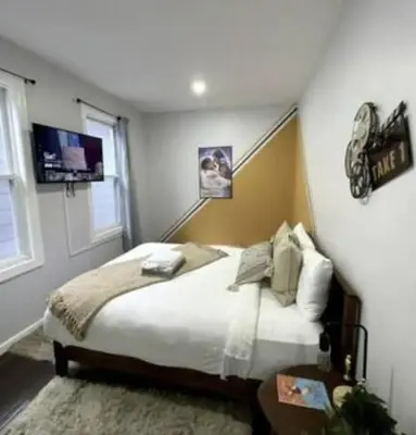 a bedroom with a bed and a window at W3S - Large 7br 3bath - Sleeps 20 - 3 Living rooms - Yard and Deck in Bayonne
