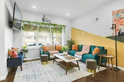 a living room with a couch and a table at W3S - Large 7br 3bath - Sleeps 20 - 3 Living rooms - Yard and Deck in Bayonne