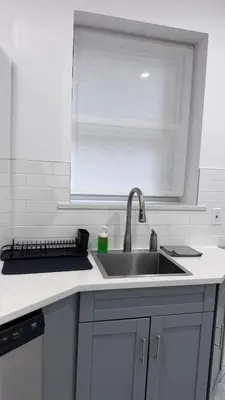a kitchen counter with a sink and a window at Beautiful Bedroom with Attached Bathroom, 15 minutes from NYC in West New York